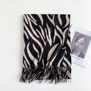 Detail of zebra-striped tassel scarf in black and beige cashmere-feel soft fabric