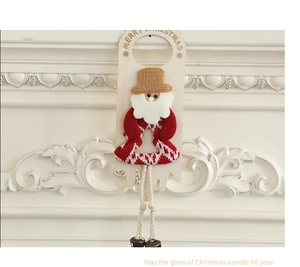 Close-up of Merry Christmas door hanger with Santa Claus motif and metal bells