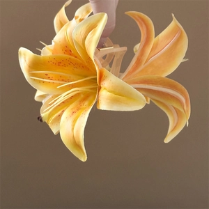 Close-up of a realistic lily flower hair claw clip with orange petals and natural spots