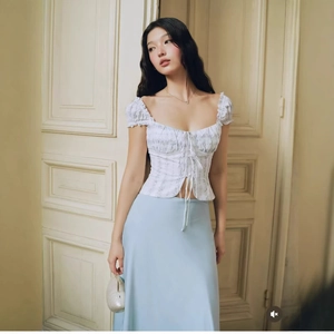 French vintage floral puff sleeve top with lace-up detail and blue satin midi skirt