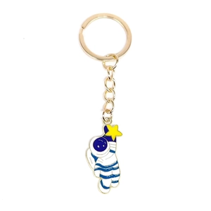 Astronaut keychain with yellow star and blue details on a gold metal ring pendant