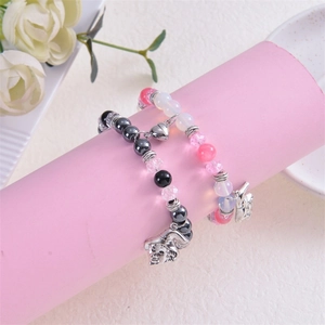 Beaded heart magnet bracelet with wizard hat and character charms on display stand