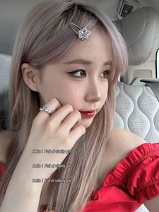 Close-up of sparkling star rhinestone hair clip and engraved star ring on a young girl