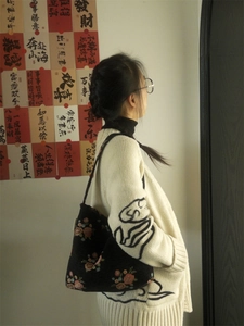 Close-up of floral print tote bag with pink flowers and wide shoulder strap