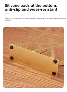Detail view of gold metal napkin holder with non-slip silicone pads and cutlery cutout
