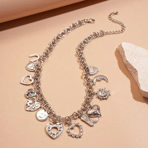 Detailed shot of silver multi-charm necklace with heart, moon and star motifs