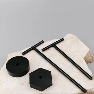 Detail of two black T-shaped acrylic earring display stands with round and hexagonal bases
