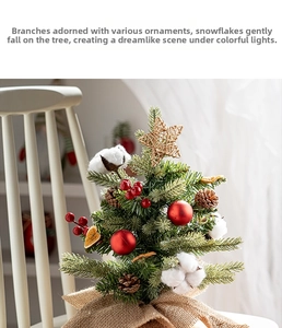 Detailed view of mini Christmas tree with red berries, pinecones and burlap base