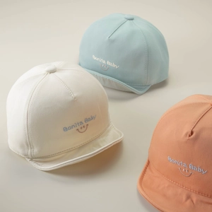 Kids soft-brim baseball caps with Bonita Baby embroidery in beige, blue, and orange pink