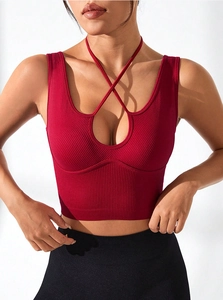Close-up of ribbed burgundy sports bra with halter criss-cross straps and front cutout