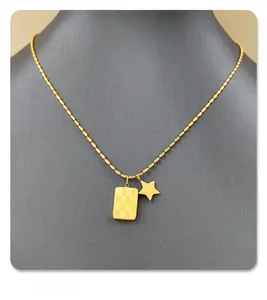 Detail view of gold star and checkerboard pendant necklace on a black mannequin