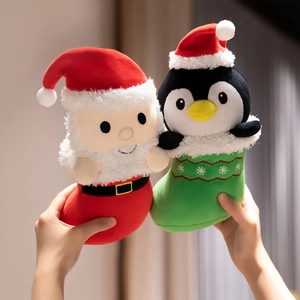 Christmas stocking plush toys featuring Santa Claus and penguin dolls in festive red and green