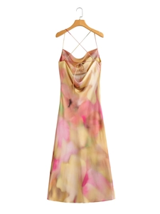 Detail of satin slip dress with criss-cross back straps and abstract tie-dye print
