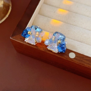 Elegant gold-plated butterfly stud earrings with blue and purple gradient glass crystals