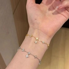 Detailed view of elegant four-leaf clover bracelet with zircon inlay on wrist