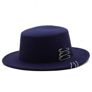 Close-up of deep purple wool felt fedora with silver safety pins and metal rings detail
