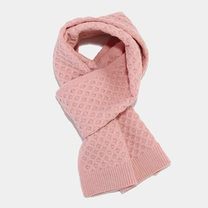 Close-up of pink honeycomb knit scarf with ribbed edges for winter warmth