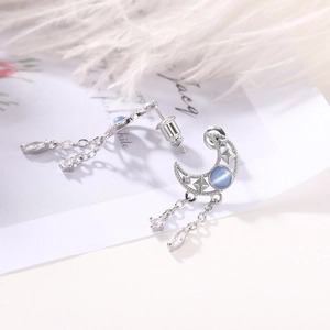 Elegant hollow moon tassel earrings with blue gemstones and white zircon drops