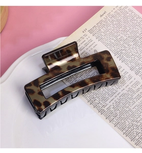 Detailed close-up of leopard print hair claw clip in a square hollow design