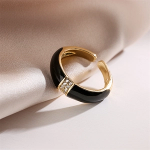 Close-up of gold plated ring featuring black enamel inlay and micro-pave zircons