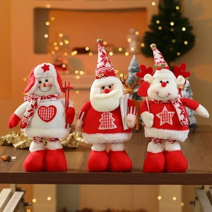 Standing Christmas plush dolls featuring Santa, snowman and reindeer on wooden table