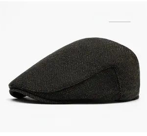Detailed side view of dark green herringbone newsboy cap showing woven fabric texture