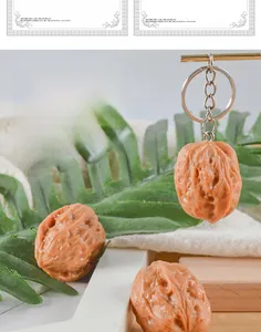 Close-up of realistic brown PVC walnut keychain with detailed textured ridges and metal ring
