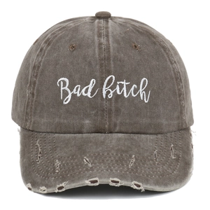 Vintage dark brown distressed baseball cap with white Bad Bitch embroidery and torn details