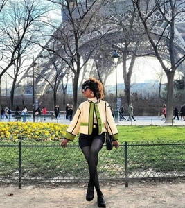 Short cream contrast jacket with green piping details styled near Eiffel Tower