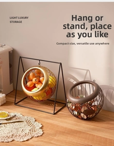 Detail of hanging metal fruit basket and coffee pod holder in elegant gold finish