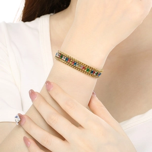 Detail of multi-colored zircon stones set in a gold-plated stainless steel bracelet