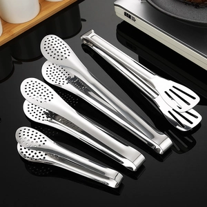 Set of four polished stainless steel food tongs for BBQ and kitchen use on a black surface