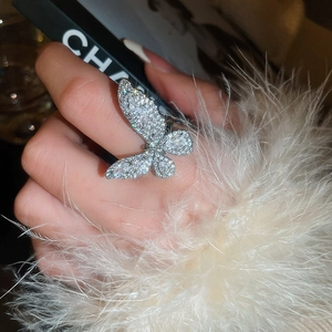 Close-up of a silver butterfly open ring featuring cubic zirconia stones on a model