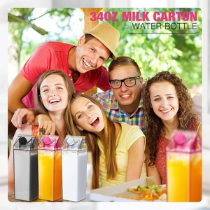 Lifestyle view of 34oz clear and pink milk carton water bottles held by happy people