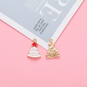 Detail of Christmas tree pendants showing white enamel front and textured gold metal back