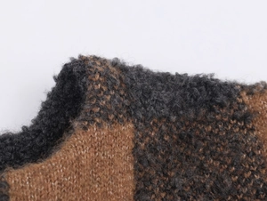 Macro shot of high-quality brown and grey plaid knit fabric with a soft mohair texture