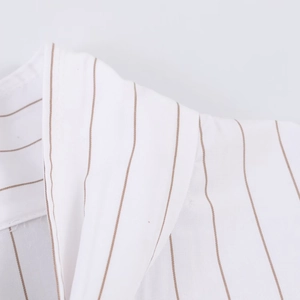 Detailed close-up of brown striped poplin shirt collar showing high-quality stitching