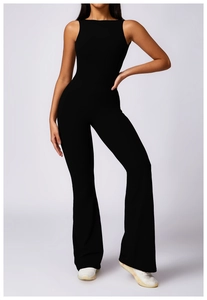 Close-up of black sleeveless backless yoga jumpsuit with flared legs on studio model