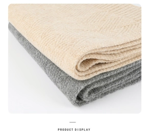 Detail showing soft cashmere-like knit scarves with herringbone pattern in beige and grey