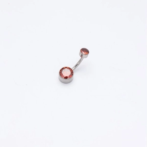 Titanium belly button ring with amber-colored round cubic zirconia in curved barbell design