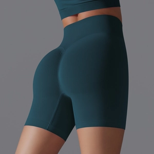 Detail of high-waisted seamless teal yoga shorts with ribbed waistband and lifting effect