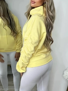 Relaxed fit light yellow women's hoodie with unique pleated sleeves and adjustable drawstring