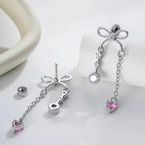 Elegant silver bow earrings with pink heart and key zircon charms, showing front and back