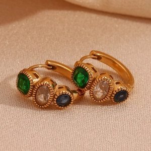 Detail of 18K gold-plated earrings with colorful sapphire and emerald style crystal stones