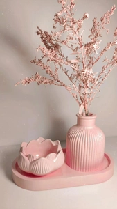 Macro shot of pink striped vase and lotus bowl on oval tray set for DIY resin molding