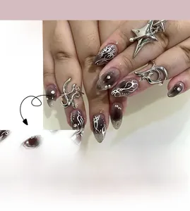 Detail of short black gradient press-on nails with white tribal patterns and small rhinestones