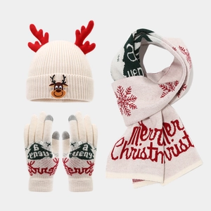 Detail of Christmas reindeer knit hat with scarf and gloves featuring festive 3D antlers