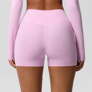 Detail view of pink high-waisted yoga shorts with V-shaped back seam and push-up effect