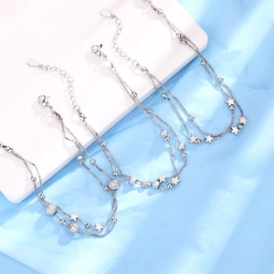 Close-up of silver star double-layered bracelet with round beads and lobster clasp detail