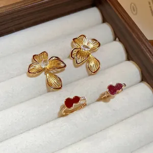 Gold plated floral stud earrings with zircon and red enamel gourd hoop earrings in wood box